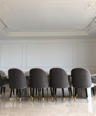 Another view of the dining room with marbled top table and 12 quilted armchairs