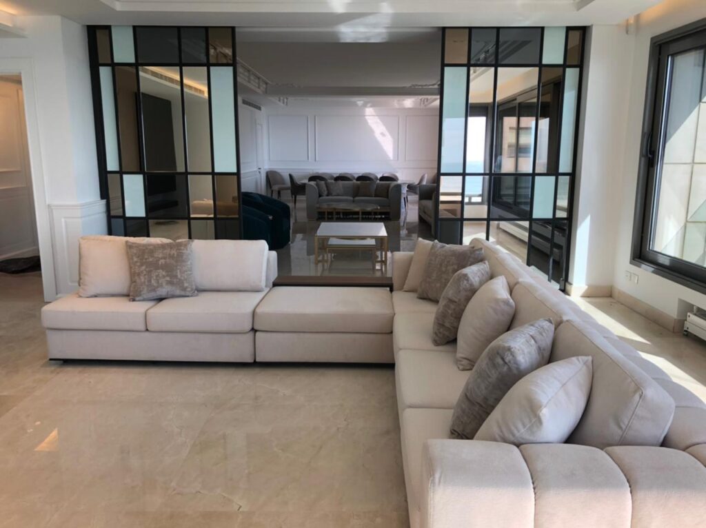 Open space containing two salons and a marble covered dining table