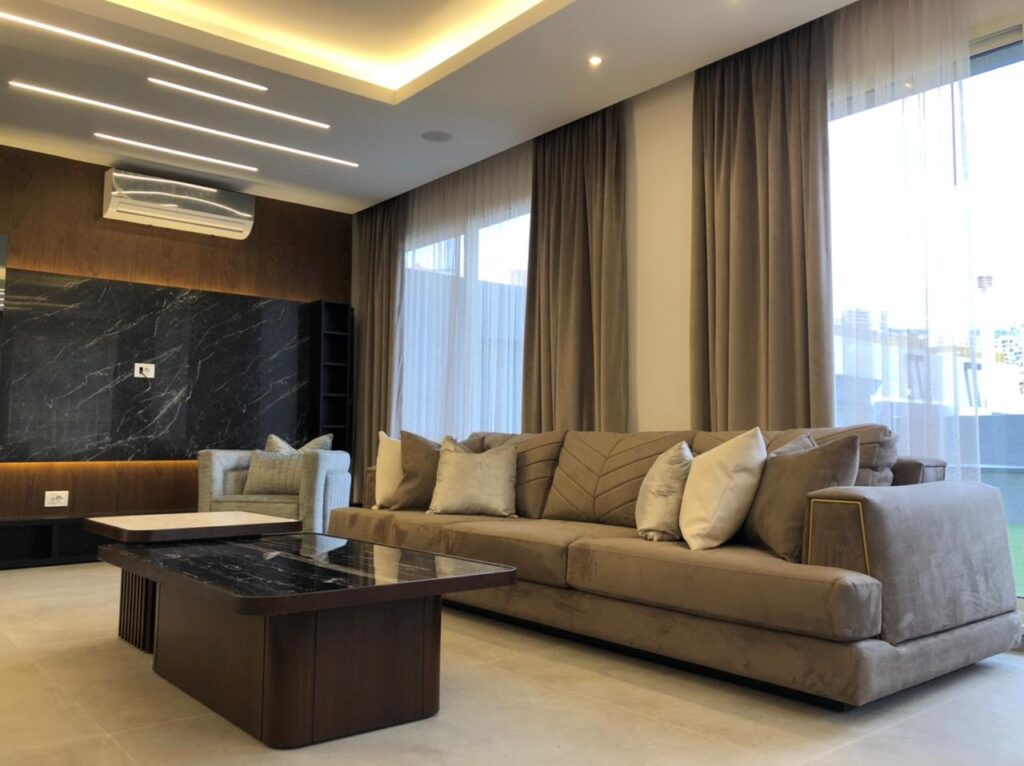 Living room with marble covered TV unit