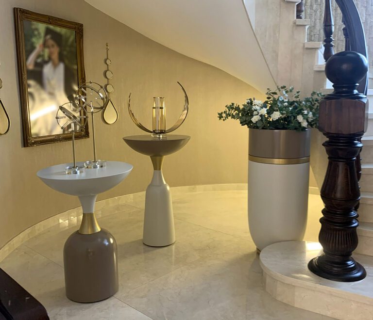 Gold and white pots, table, and accessories paired with the perfect lighting making for a grand enterance