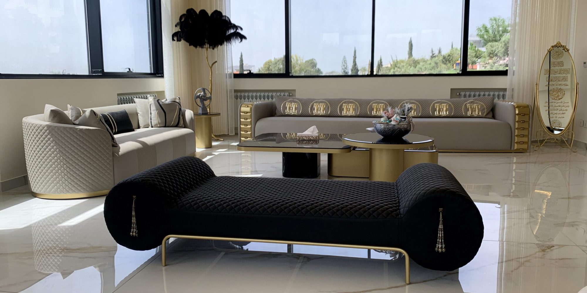 Second seater area with a 4.5-seater greige Napoleon sofa, another 2-seater beige sofa, black bench, and the feather floor lamp